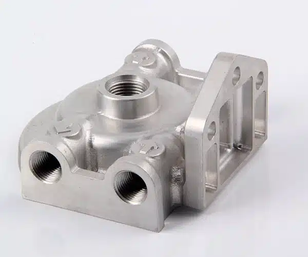 CNC machined aluminum part by ZhuanXin Precision with threaded holes and smooth finish for industrial use.